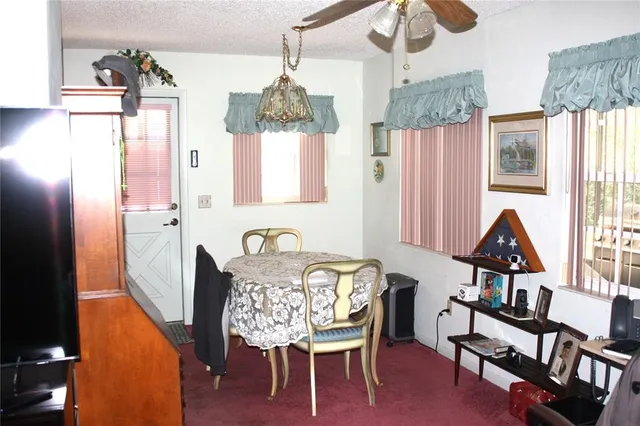 a view of a dining room with furniture and a chandelier