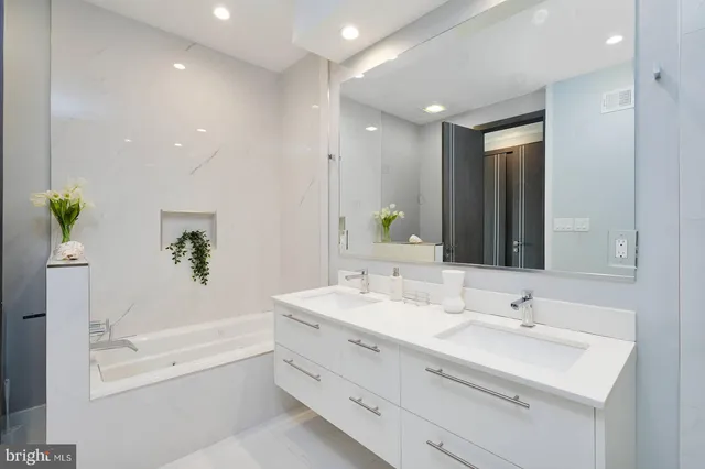 a bathroom with a sink toilet and a mirror