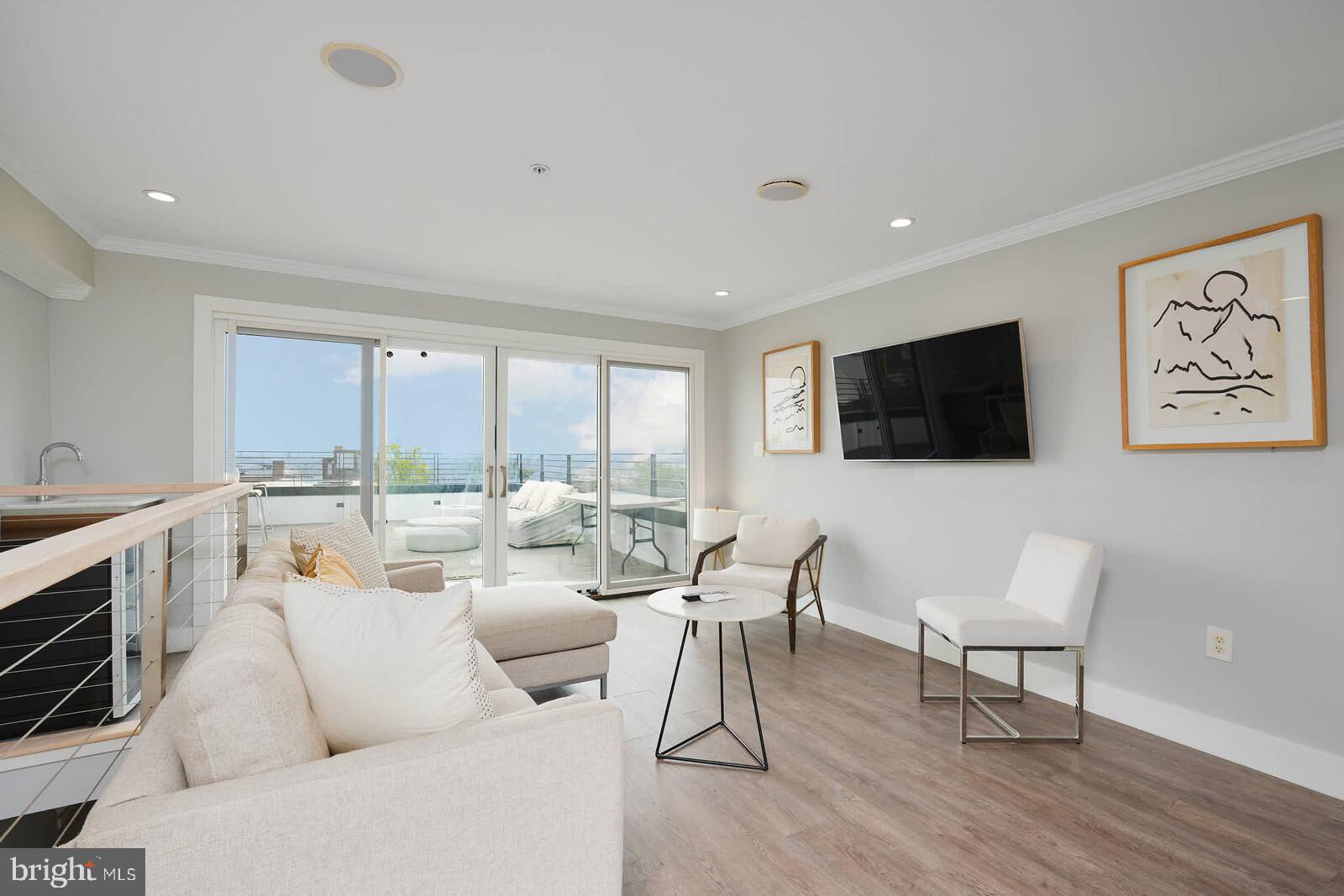 1461 Chapin Street Northwest Washington, DC 20009 - Photo 29 of 67 a living room with furniture a flat screen tv and a large window
