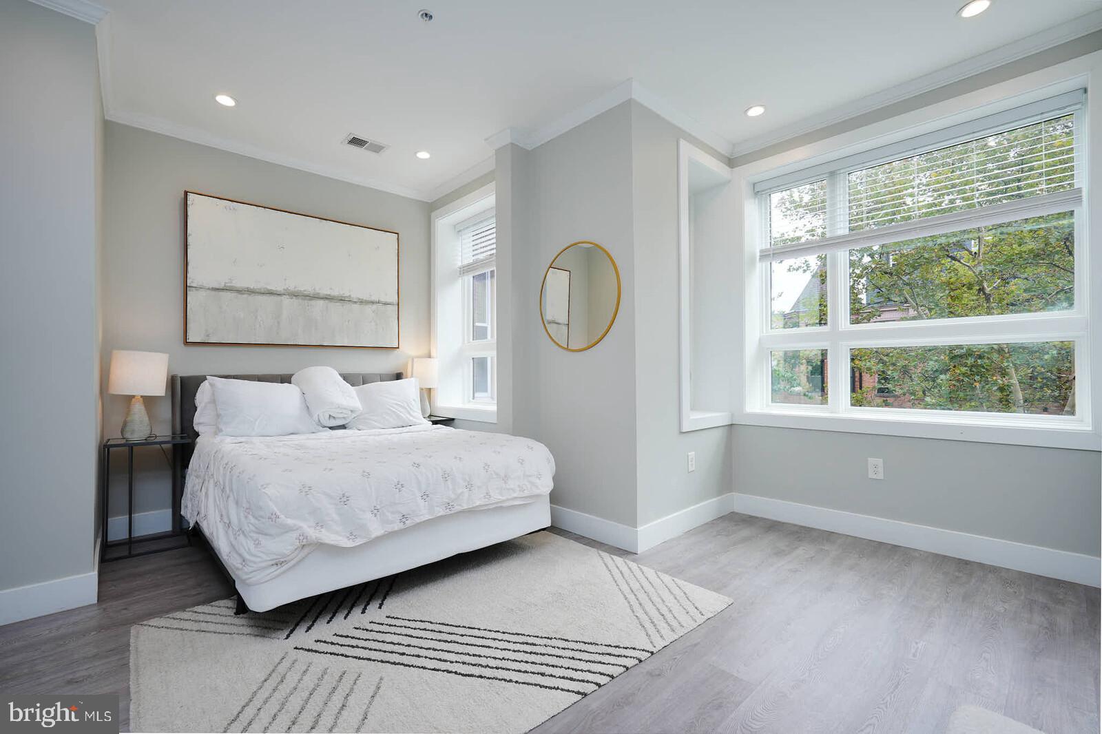 1461 Chapin Street Northwest Washington, DC 20009 - Photo 40 of 67 a bedroom with a large bed and a window
