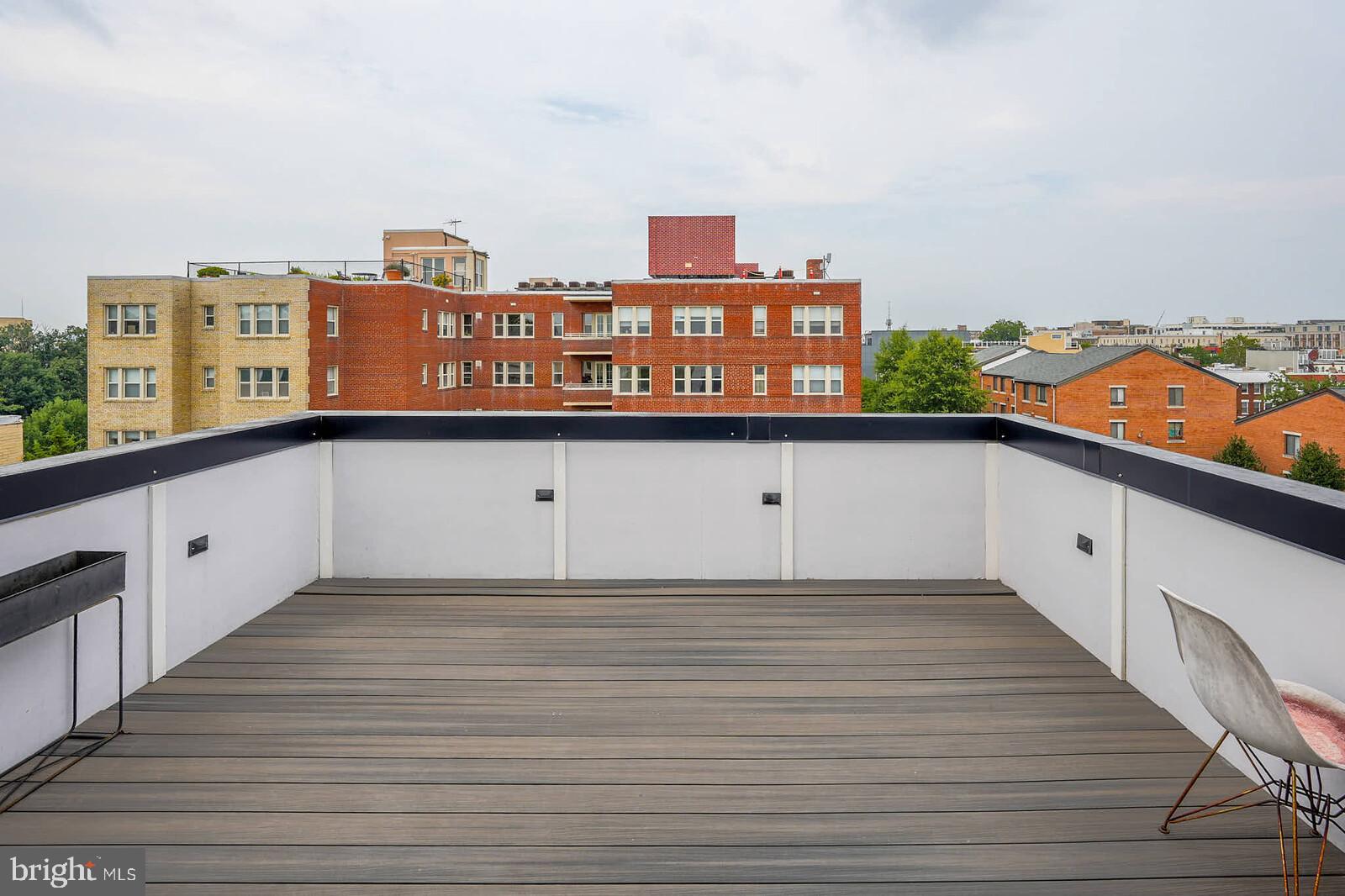 1461 Chapin Street Northwest Washington, DC 20009 - Photo 4 of 67 a view of a kitchen with kitchen island stainless steel appliances wooden floor and a large window