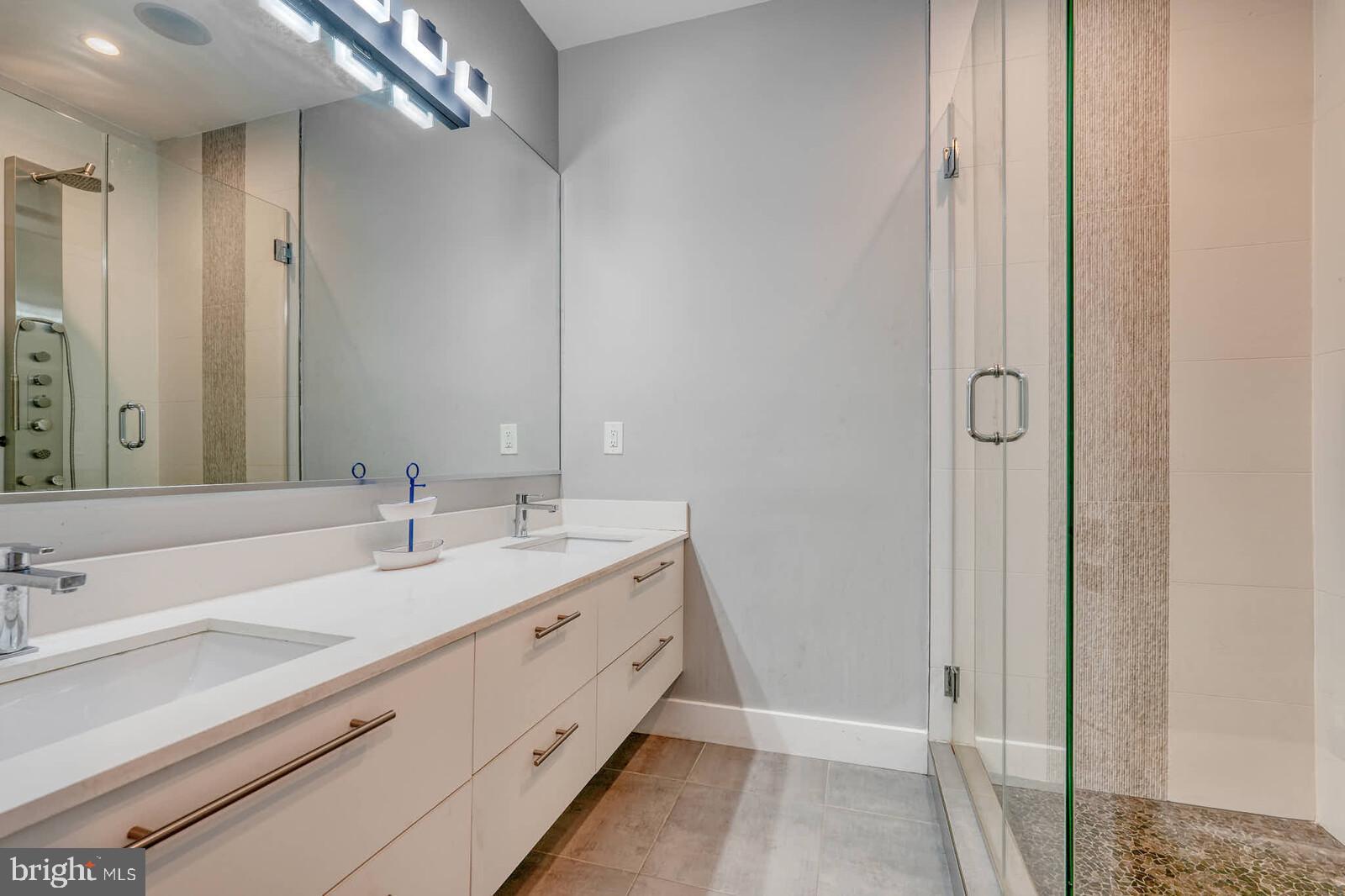 1461 Chapin Street Northwest Washington, DC 20009 - Photo 51 of 67 a bathroom with a double vanity sink and mirror