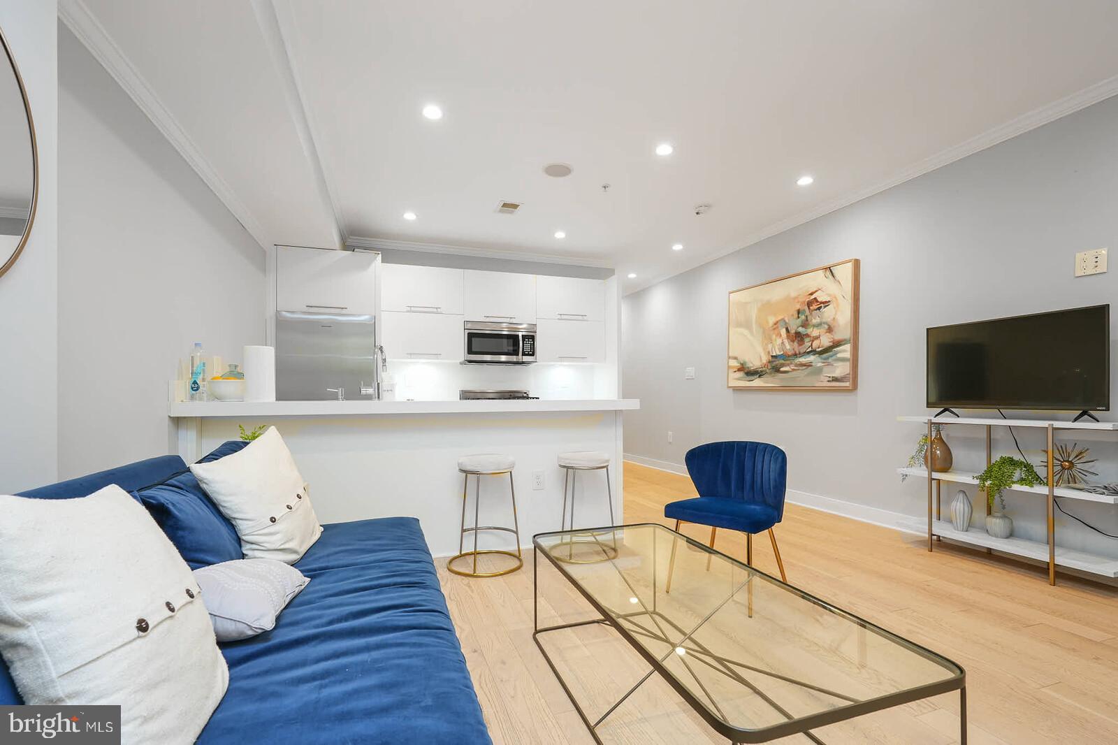 1461 Chapin Street Northwest Washington, DC 20009 - Photo 63 of 67 a living room with furniture and a flat screen tv with wooden floor