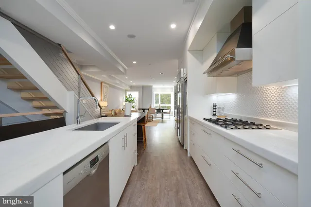 a stove top oven sitting inside of a kitchen