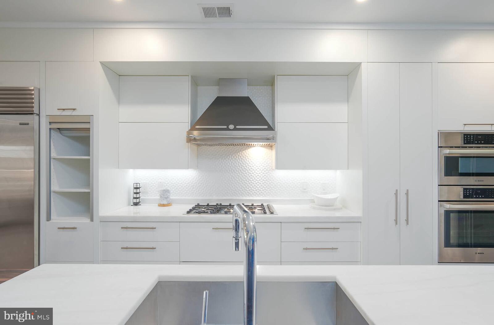 1461 Chapin Street Northwest Washington, DC 20009 - Photo 10 of 67 a kitchen with kitchen island a sink stove and refrigerator