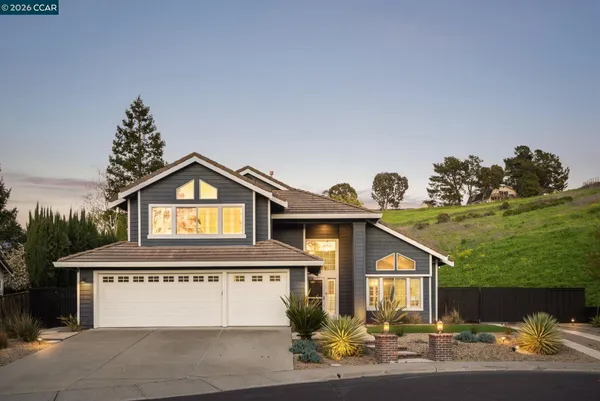 a front view of a house with a yard and garage