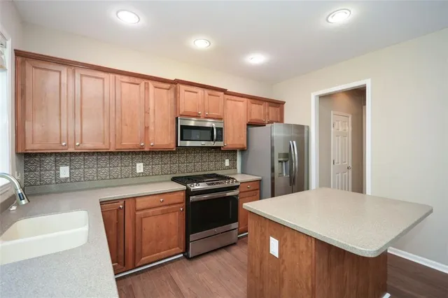 a kitchen with a refrigerator sink and stove
