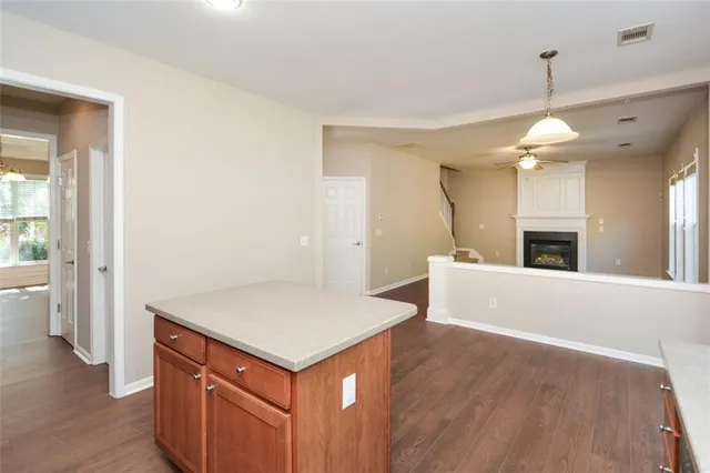 a view of a kitchen with a sink and a refrigerator