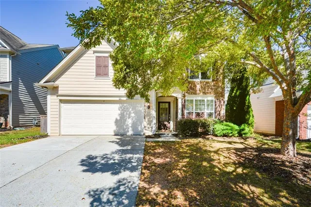 a front view of a house with a yard