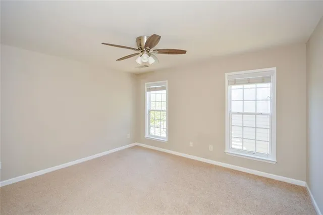a view of empty room with ceiling fan