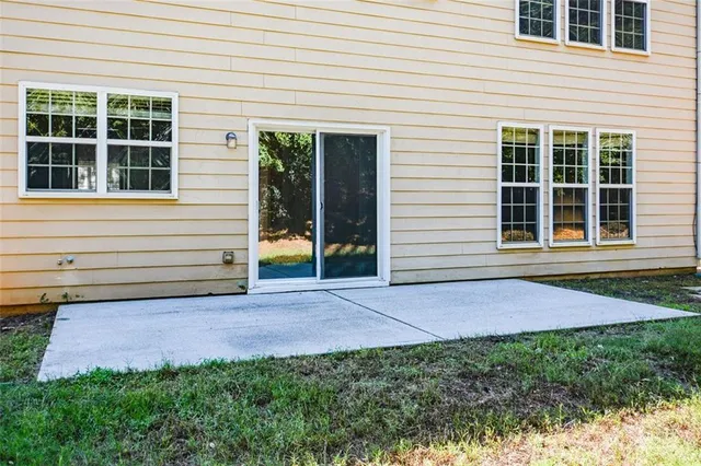 a view of a house with backyard porch and sitting area