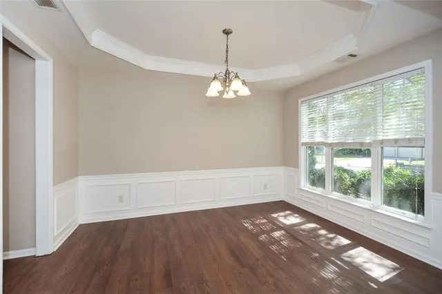 a view of a room with wooden floor and windows