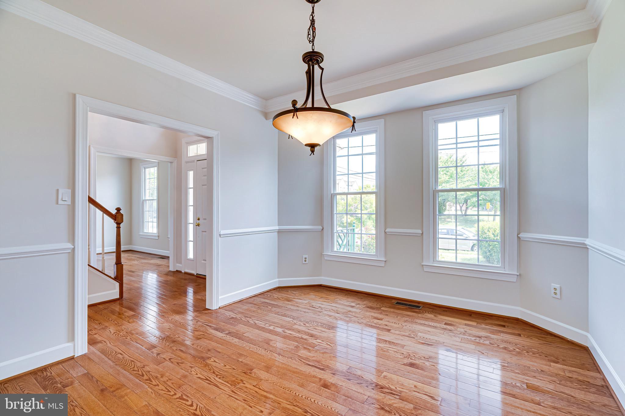 1936 Lord Fairfax Road Vienna, VA 22182 - Photo 13 of 81 a view of an empty room with wooden floor and a window