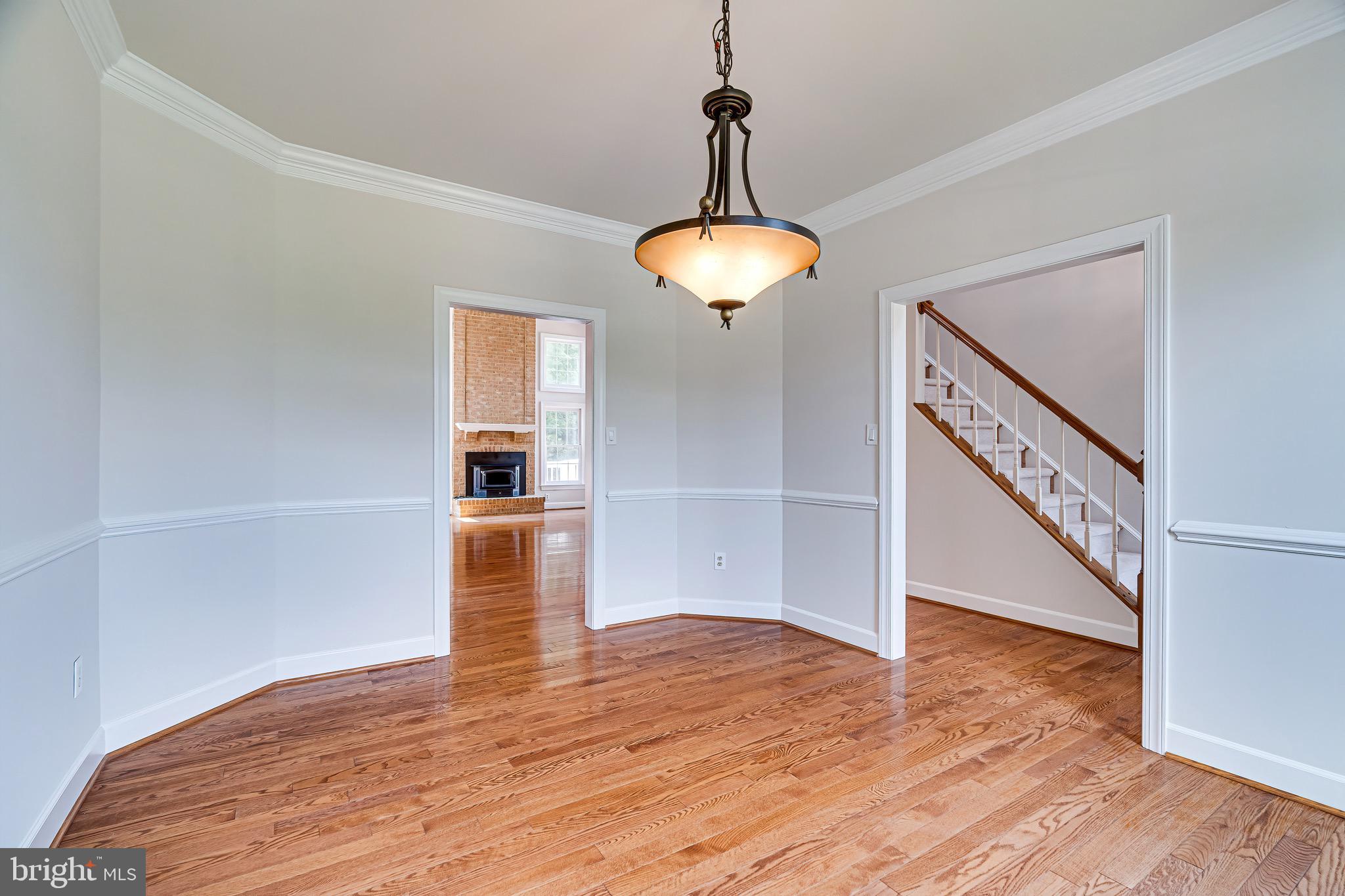 1936 Lord Fairfax Road Vienna, VA 22182 - Photo 14 of 81 a view of an empty room with wooden floor and a window