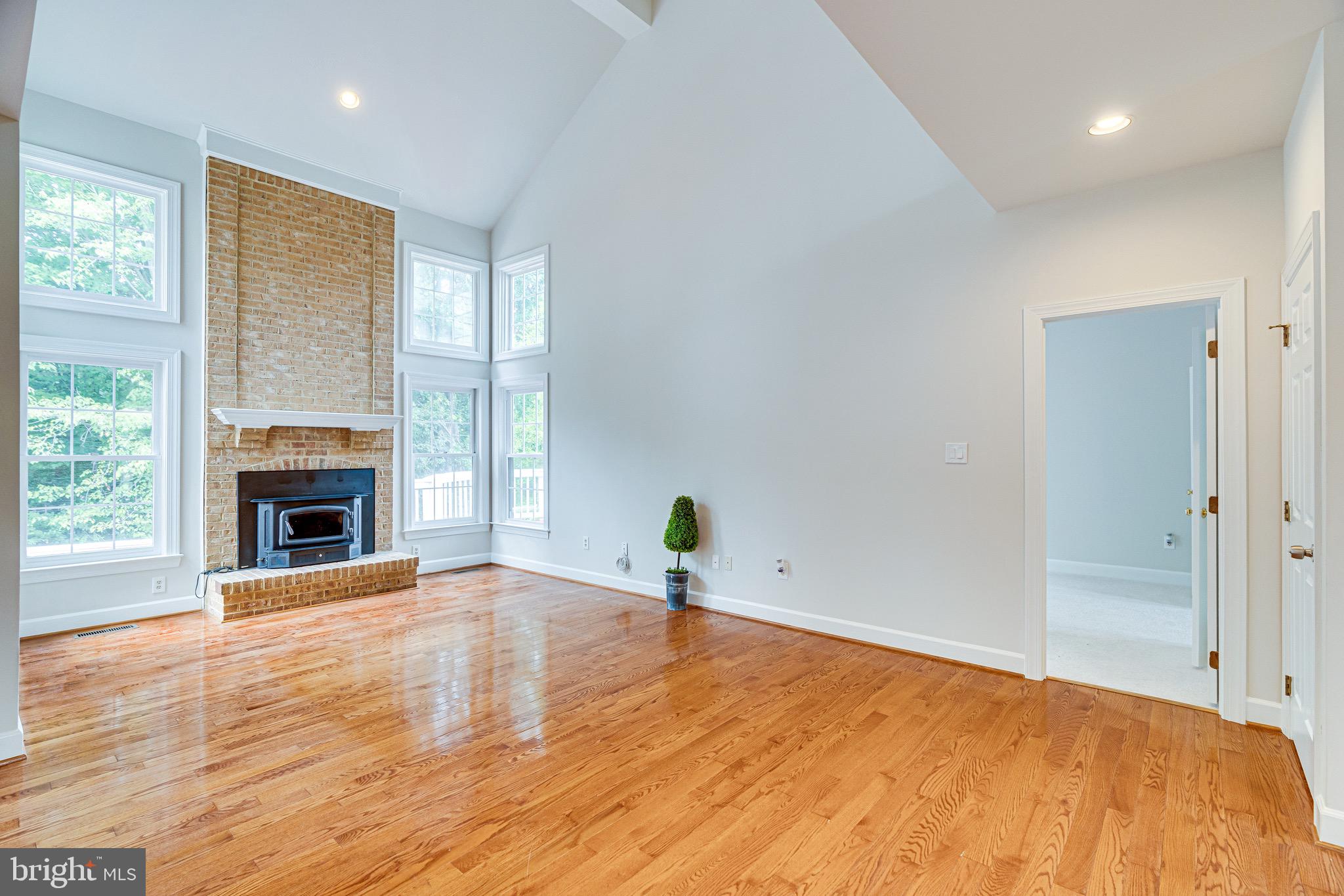 1936 Lord Fairfax Road Vienna, VA 22182 - Photo 18 of 81 a view of a room with wooden floor and a fireplace