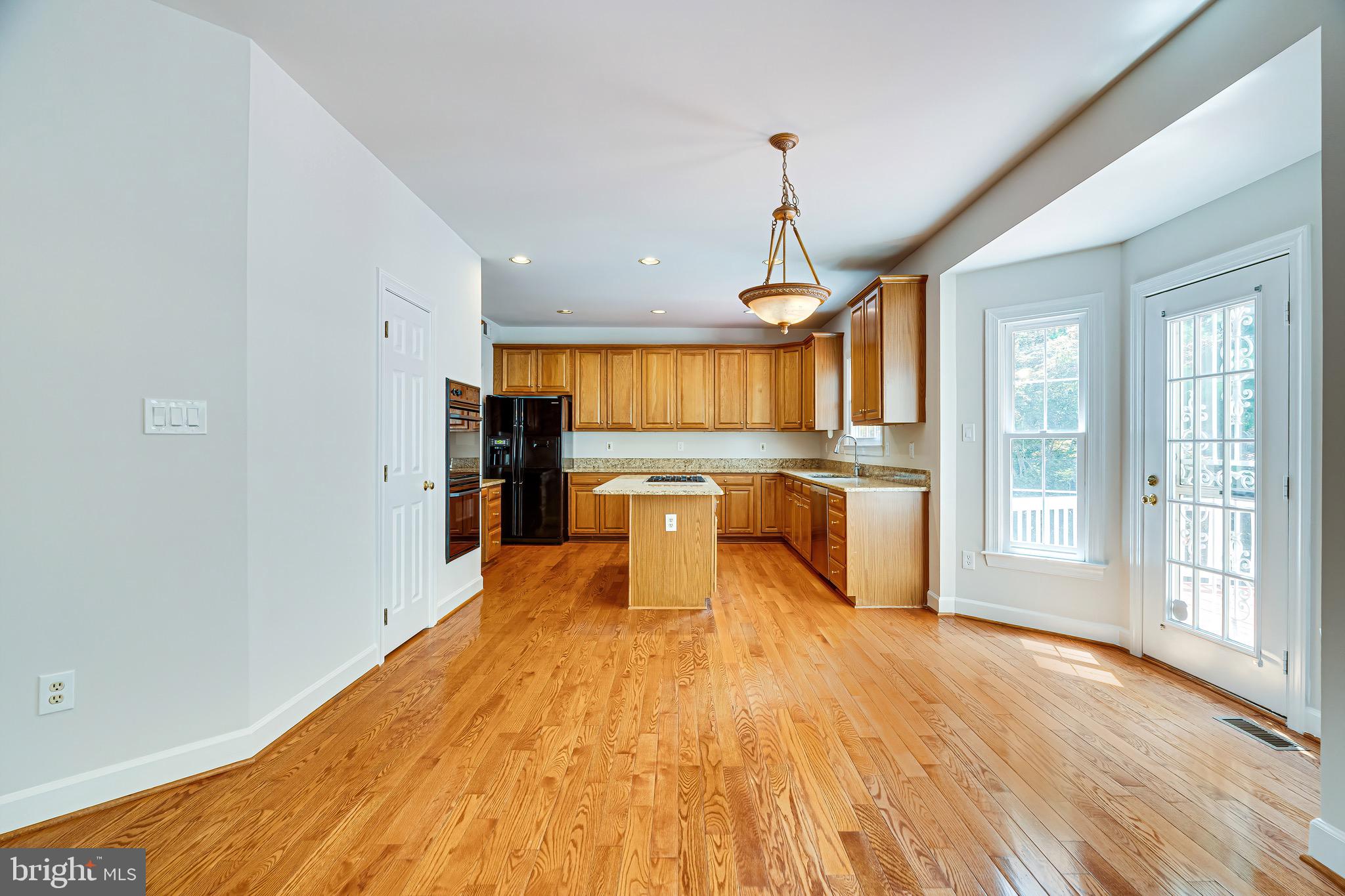 1936 Lord Fairfax Road Vienna, VA 22182 - Photo 19 of 81 a large kitchen with stainless steel appliances granite countertop a refrigerator and microwave