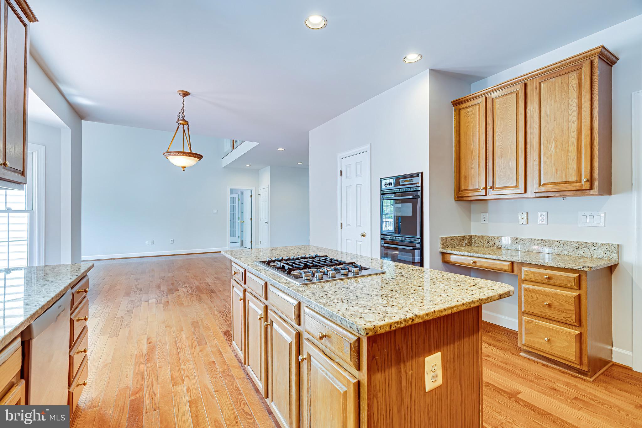 1936 Lord Fairfax Road Vienna, VA 22182 - Photo 21 of 81 a kitchen that has a stove and a table in it