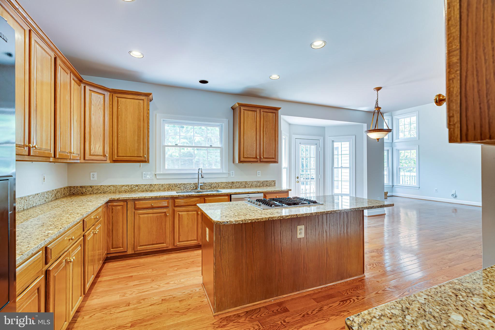 1936 Lord Fairfax Road Vienna, VA 22182 - Photo 22 of 81 a kitchen with stainless steel appliances granite countertop a sink stove and wooden cabinets