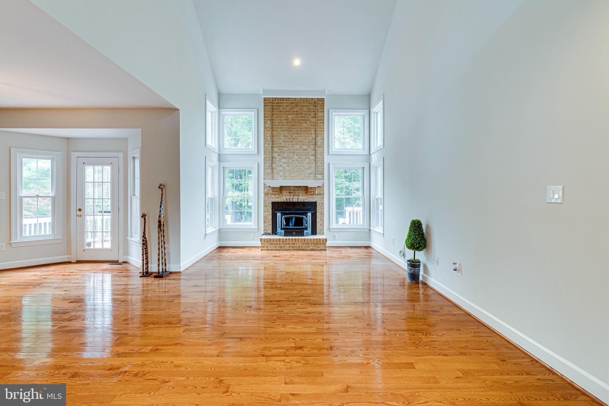 1936 Lord Fairfax Road Vienna, VA 22182 - Photo 24 of 81 a view of an empty room with wooden floor and a fireplace