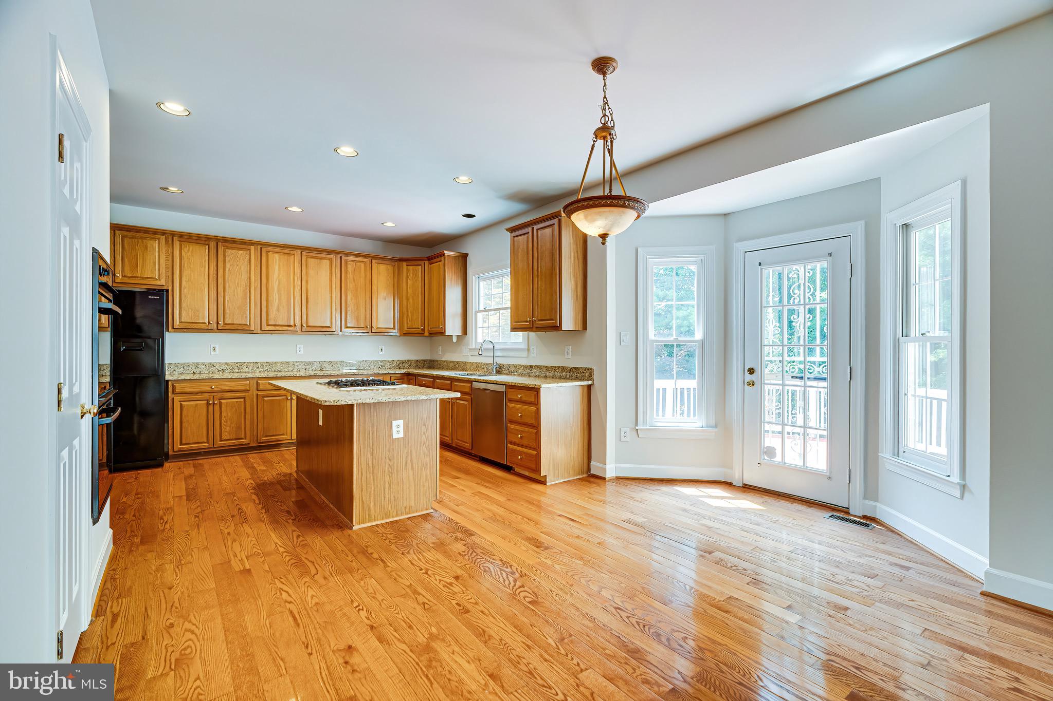 1936 Lord Fairfax Road Vienna, VA 22182 - Photo 26 of 81 a large kitchen with stainless steel appliances granite countertop a stove and a sink