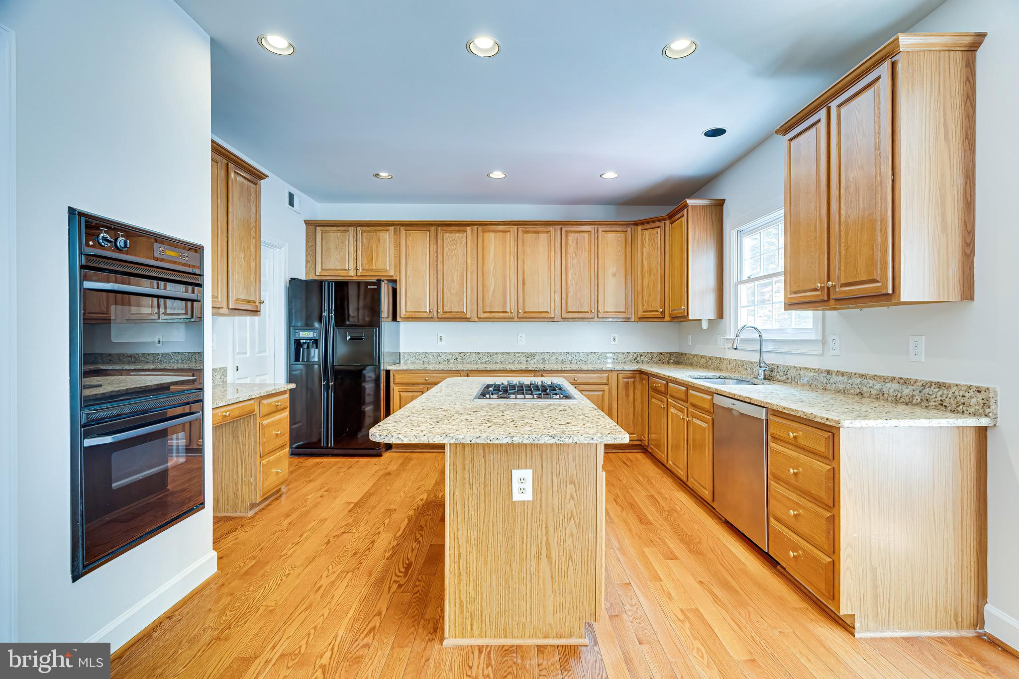 1936 Lord Fairfax Road Vienna, VA 22182 - Photo 27 of 81 a kitchen with stainless steel appliances granite countertop a stove a sink and a refrigerator