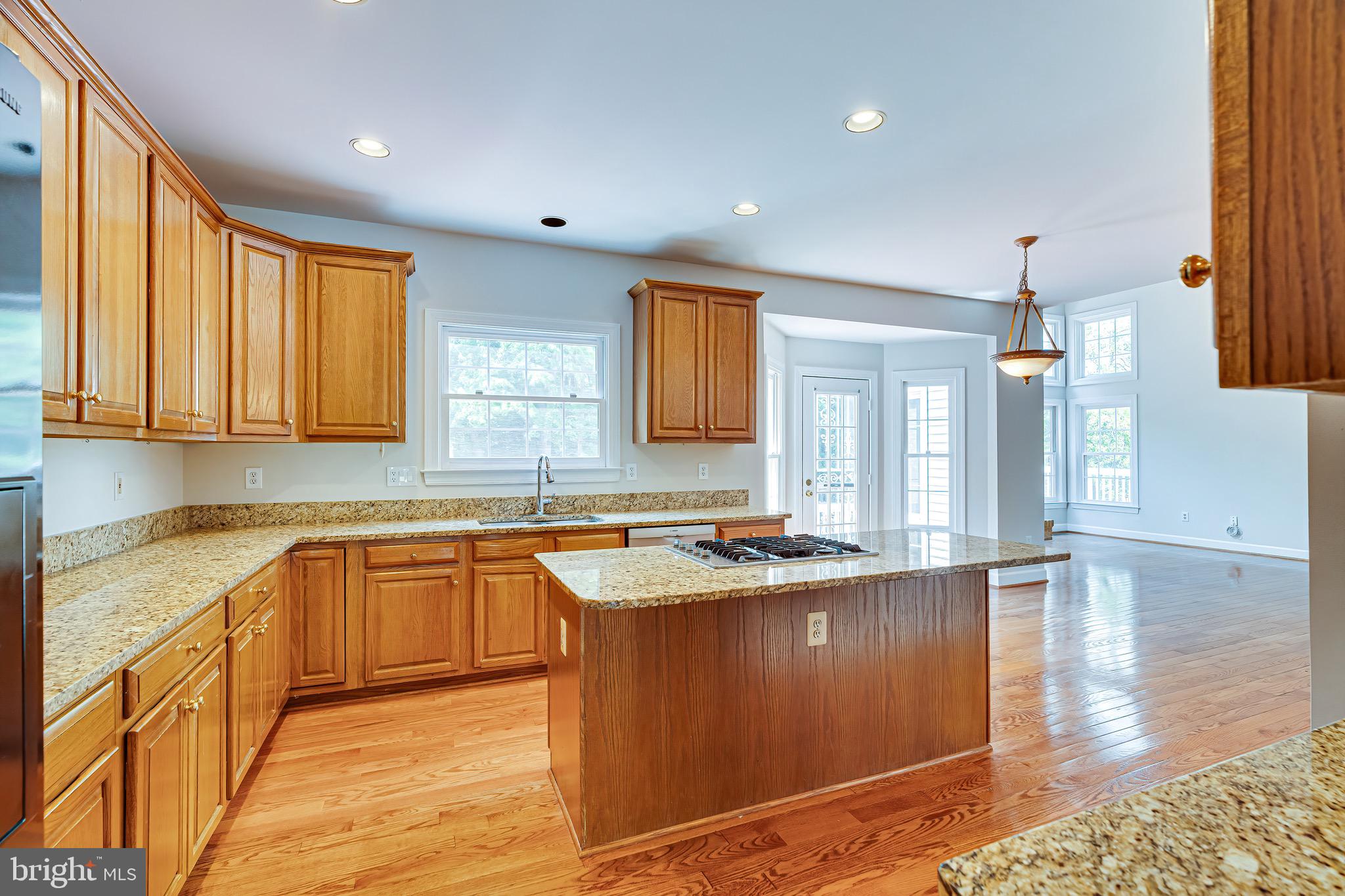 1936 Lord Fairfax Road Vienna, VA 22182 - Photo 29 of 81 a kitchen with stainless steel appliances granite countertop a sink stove and wooden cabinets