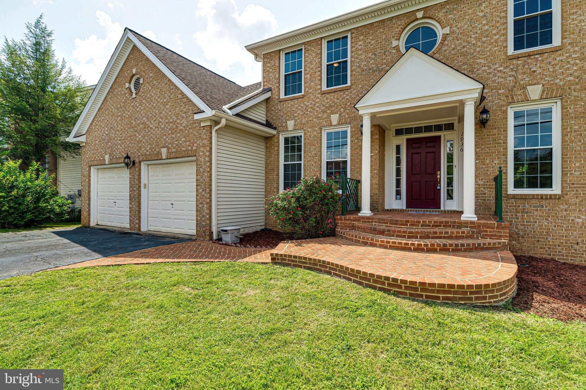 1936 Lord Fairfax Road Vienna, VA 22182 - Photo 3 of 81 a view of a white house with a small yard and large tree