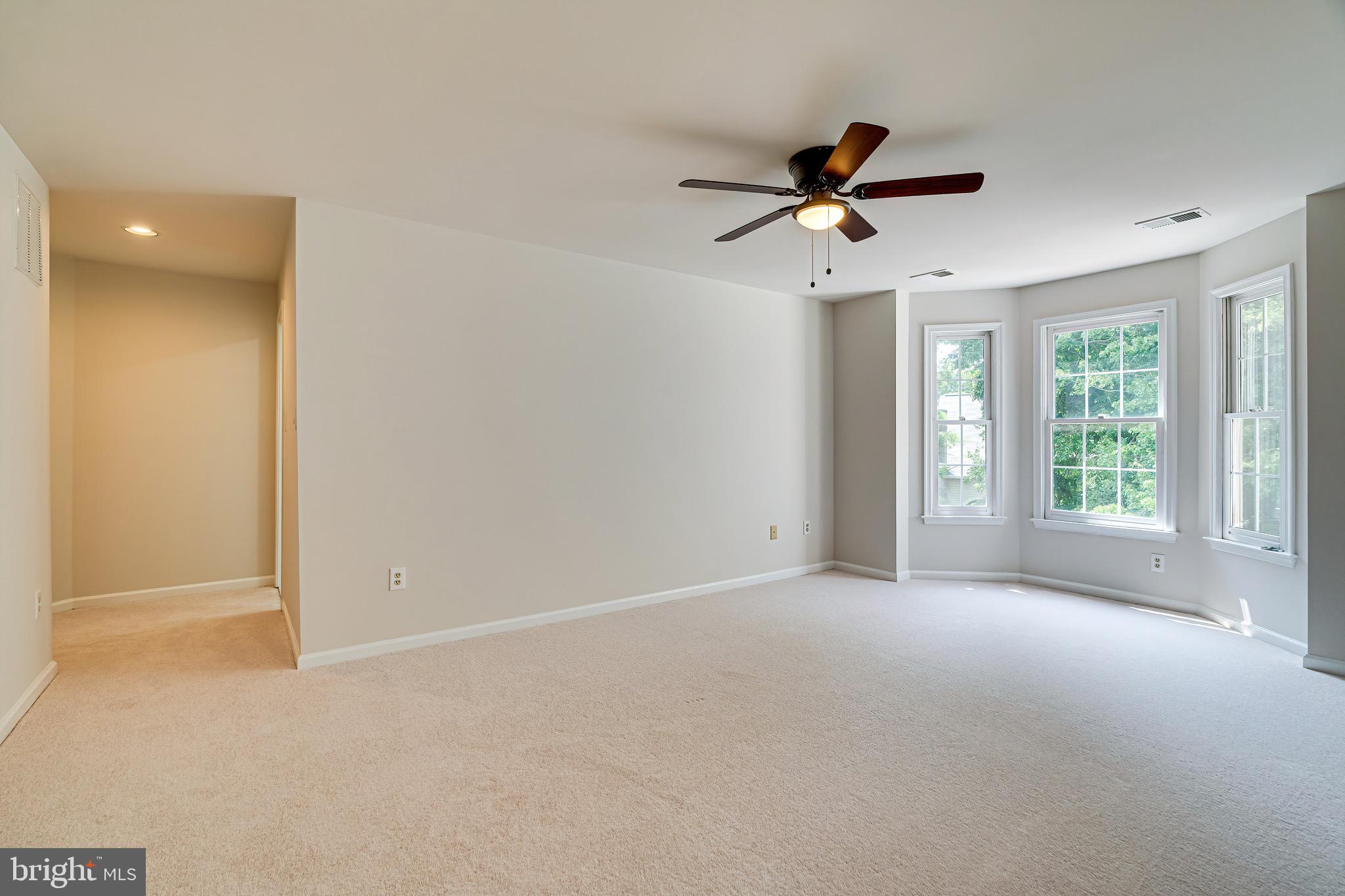 1936 Lord Fairfax Road Vienna, VA 22182 - Photo 37 of 81 an empty room with windows and fan