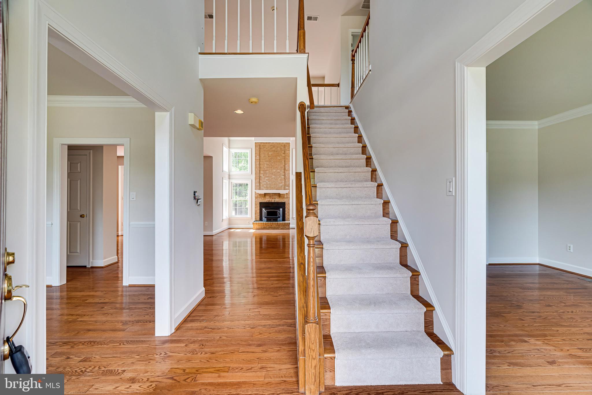 1936 Lord Fairfax Road Vienna, VA 22182 - Photo 4 of 81 a view of a hallway with wooden floor and staircase