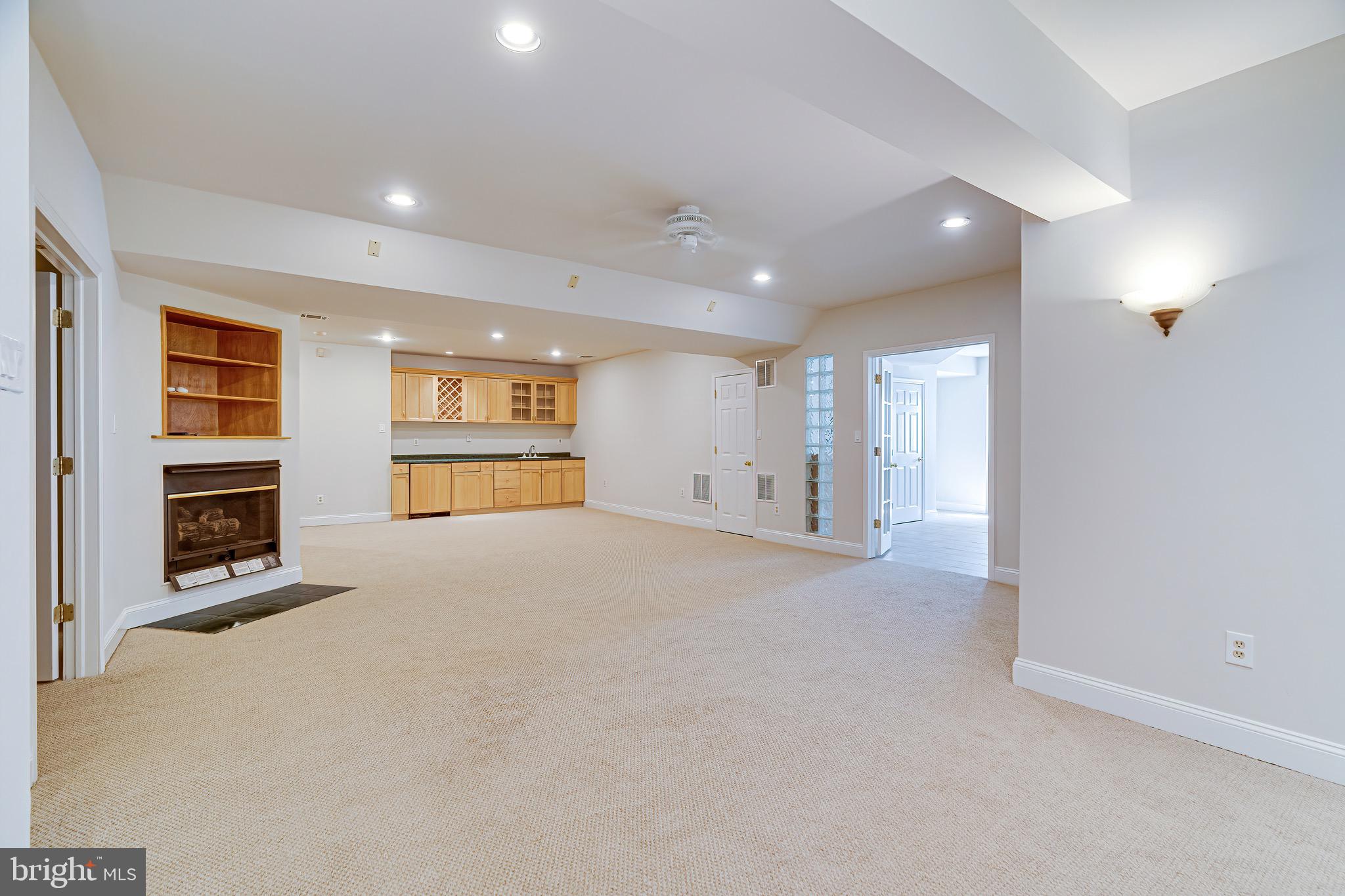 1936 Lord Fairfax Road Vienna, VA 22182 - Photo 54 of 81 a view of an empty room with a fireplace and a window