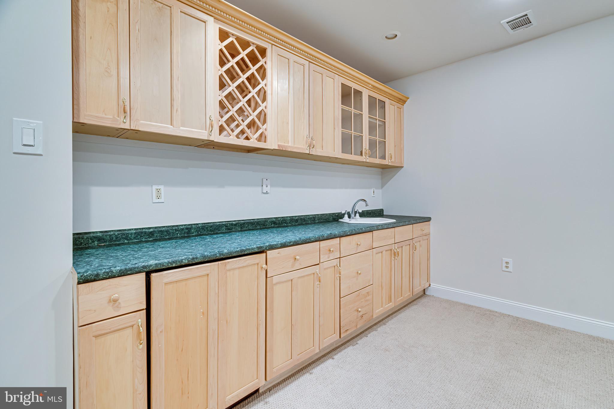 1936 Lord Fairfax Road Vienna, VA 22182 - Photo 57 of 81 a kitchen with granite countertop white cabinets and sink