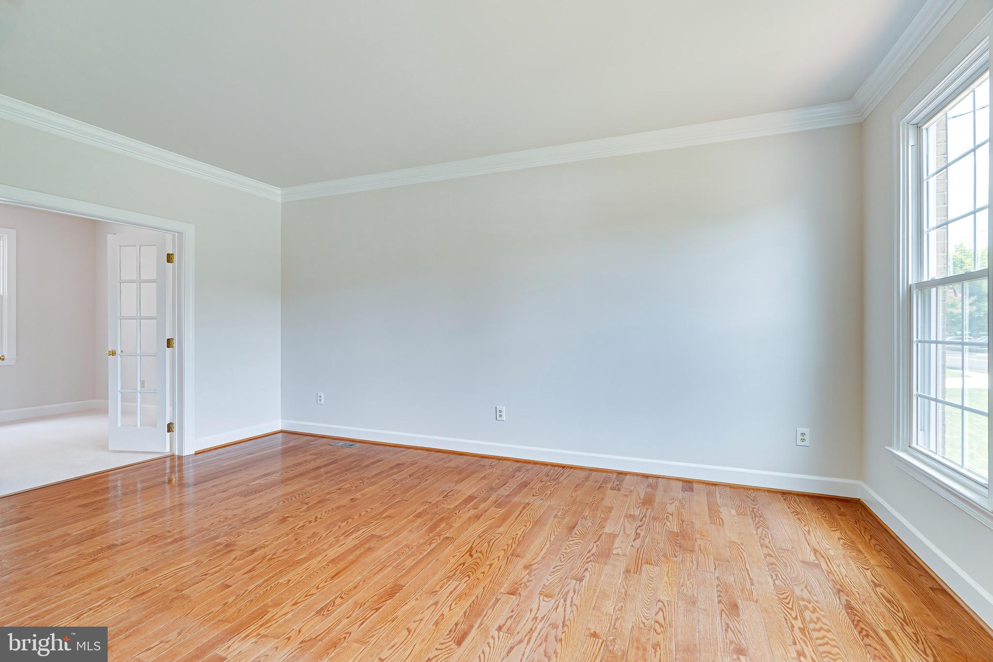 1936 Lord Fairfax Road Vienna, VA 22182 - Photo 6 of 81 wooden floor in an empty room with a window