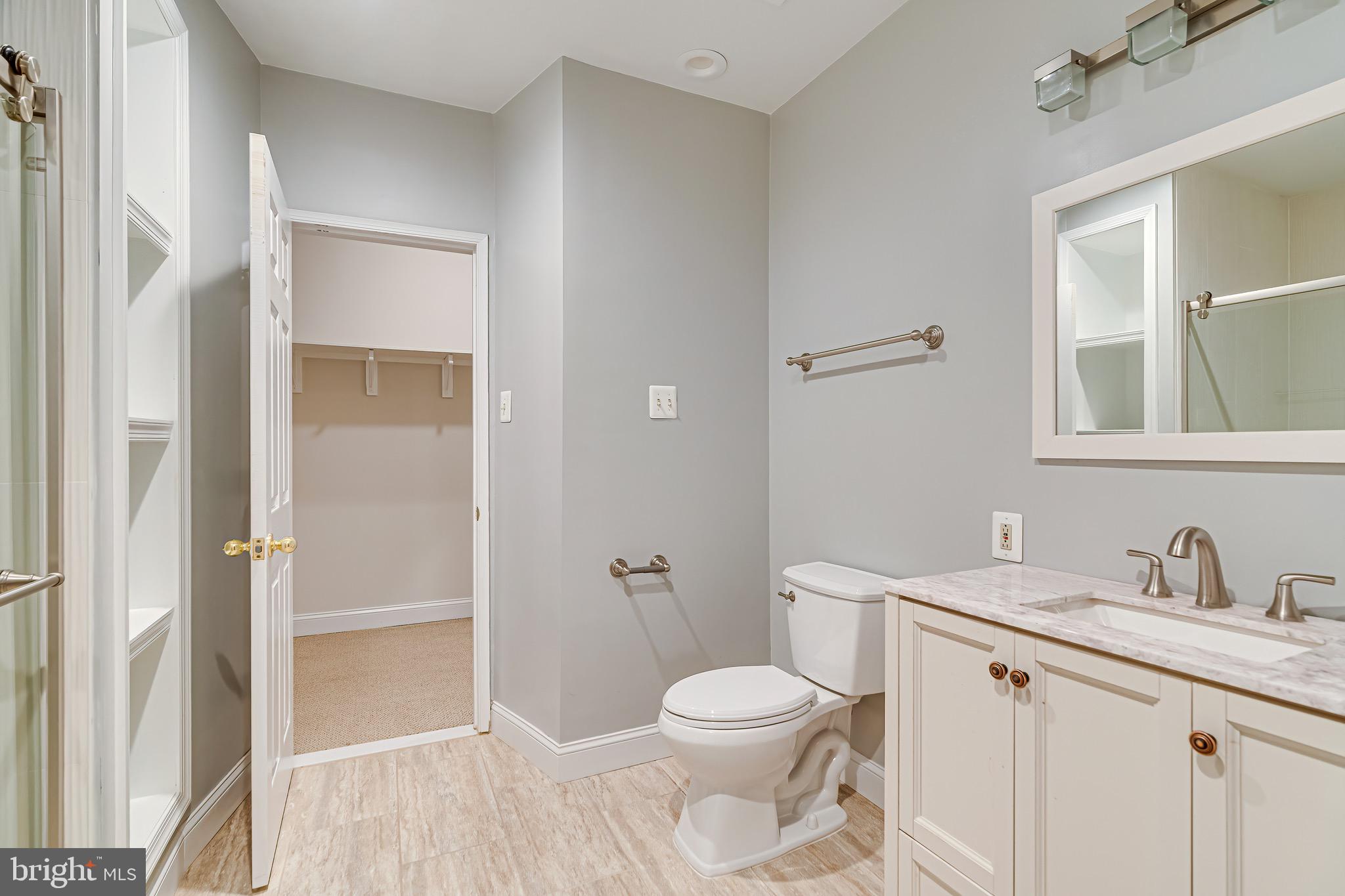 1936 Lord Fairfax Road Vienna, VA 22182 - Photo 63 of 81 a bathroom with a toilet a sink and shower
