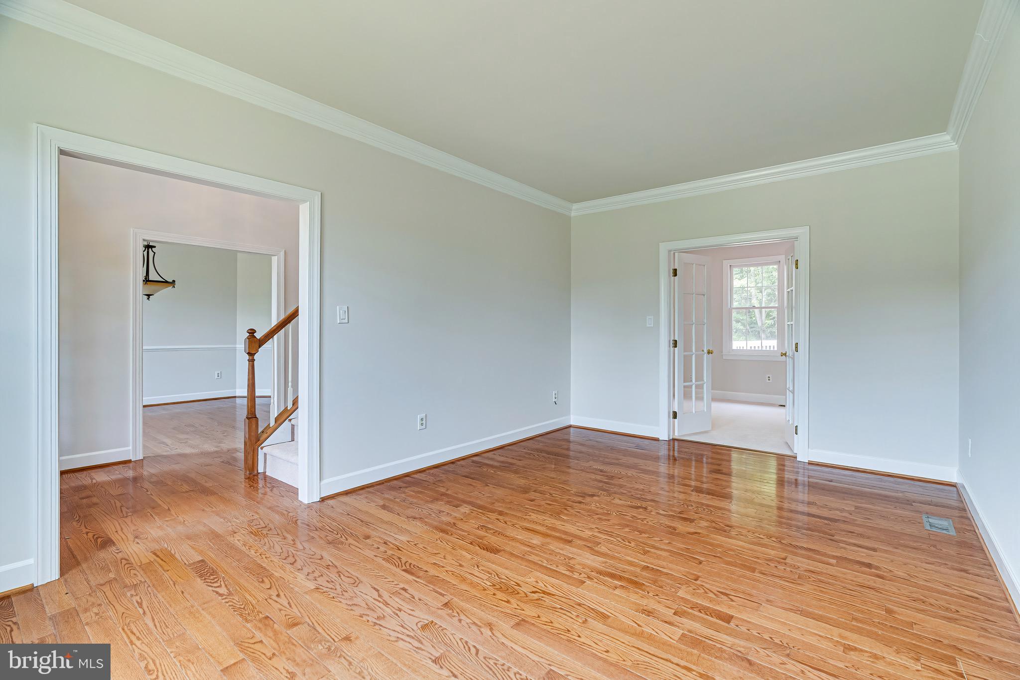 1936 Lord Fairfax Road Vienna, VA 22182 - Photo 7 of 81 a view of empty room with wooden floor and kitchen
