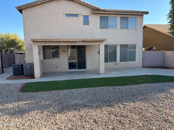 a front view of a house with a garden and yard