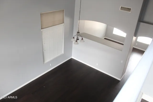 en empty room with wooden floor