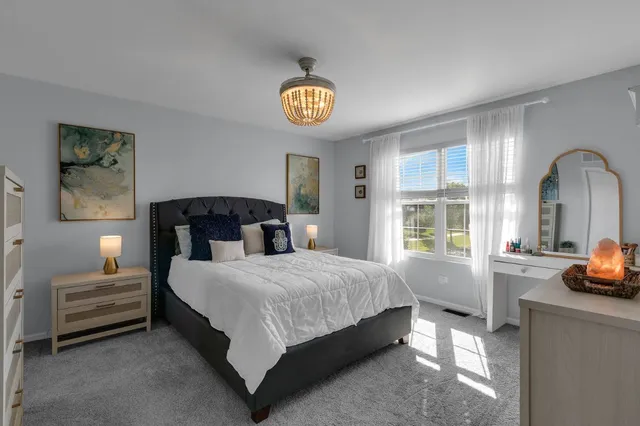 a bedroom with a bed and a large window