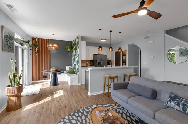 a living room with furniture and a chandelier