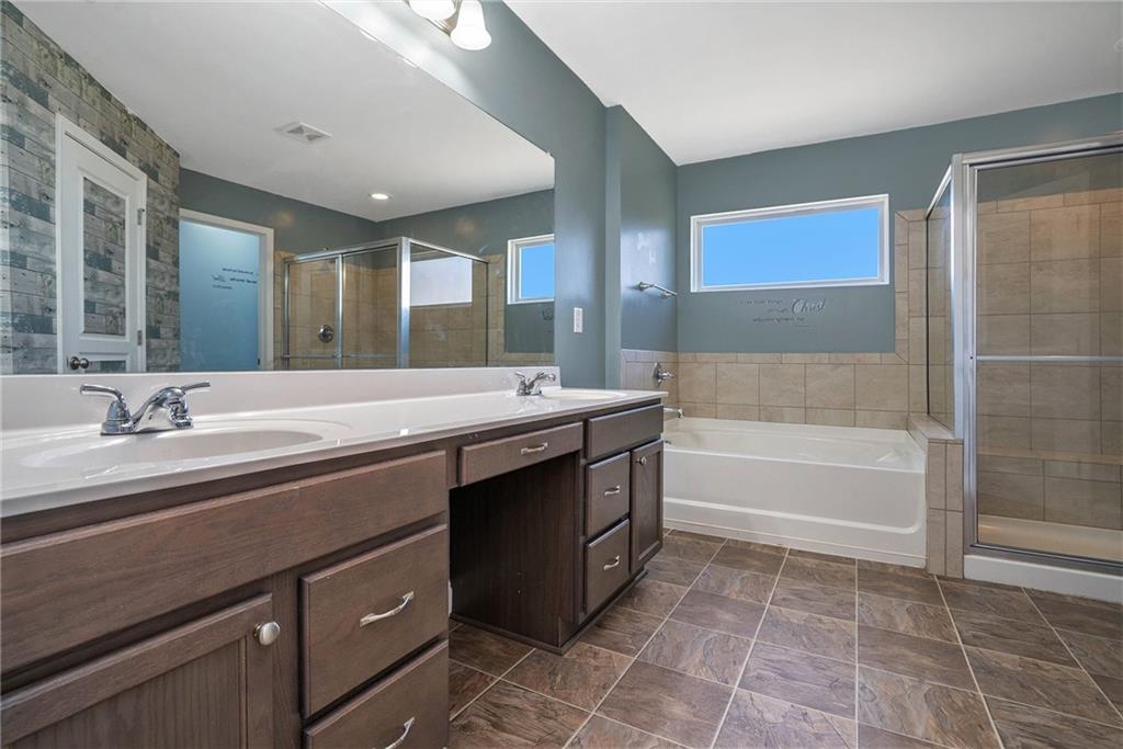 115 Floating Leaf Way Dallas, GA 30132 - Photo 20 of 47 a bathroom with a sink double vanity and a bathtub