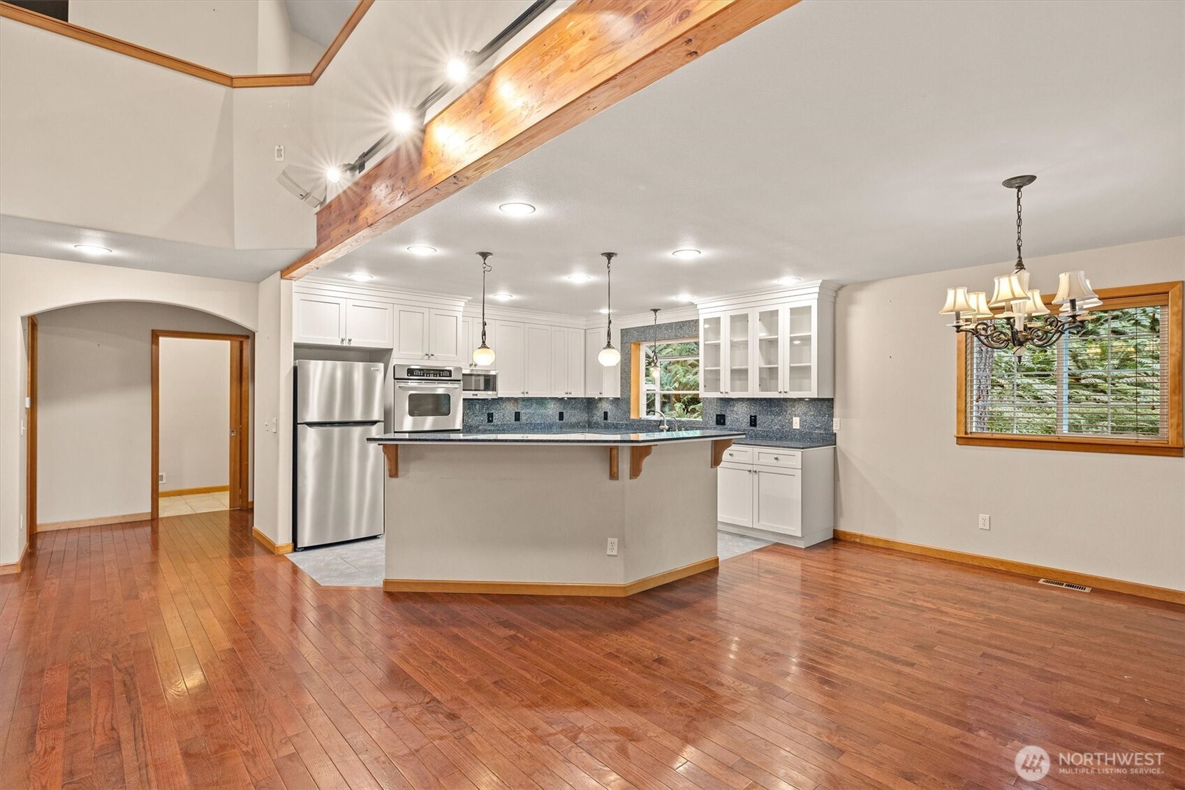 28 Grand View Lane Bellingham, WA 98229 - Photo 11 of 33 a living room with stainless steel appliances kitchen island granite countertop a refrigerator a stove top oven and a dining table with wooden floor