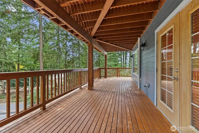 a view of an empty room with a window and a fireplace