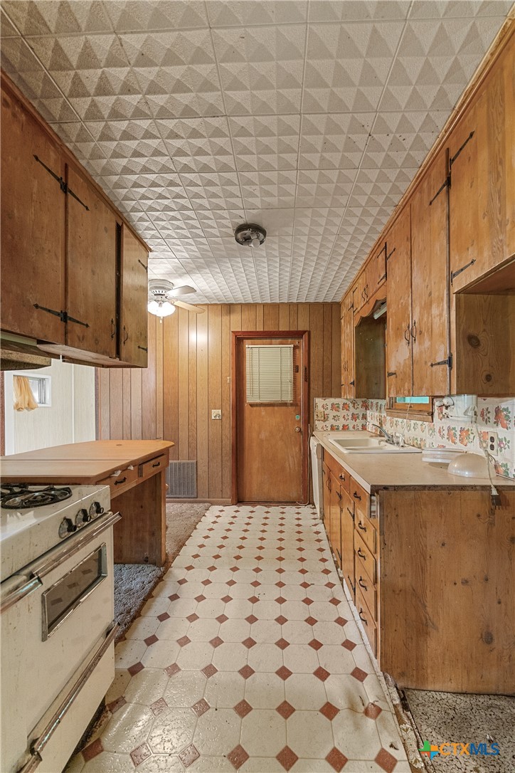 401 Kerr Street Edna, TX 77957 - Photo 12 of 23 a large kitchen with stainless steel appliances a stove a sink dishwasher and cabinets