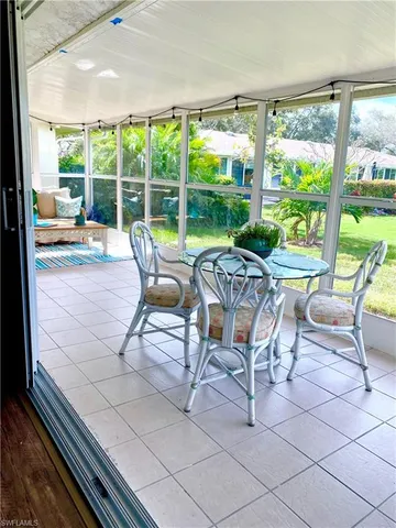 a building outdoor space with patio furniture and garden view