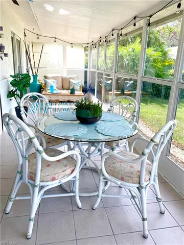 a dining room with furniture and floor to ceiling windows