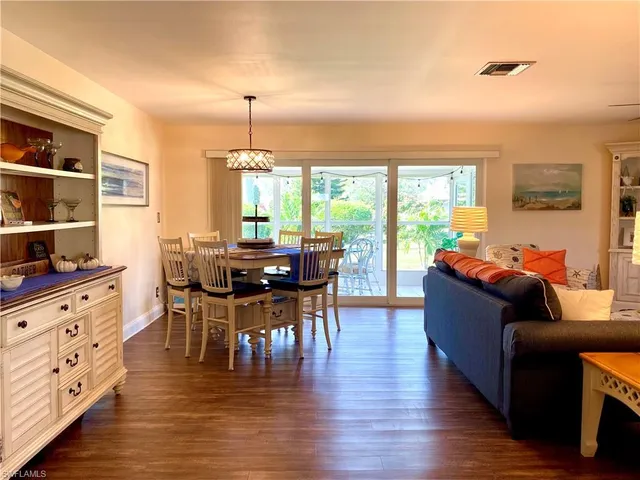 a living room with furniture and large windows