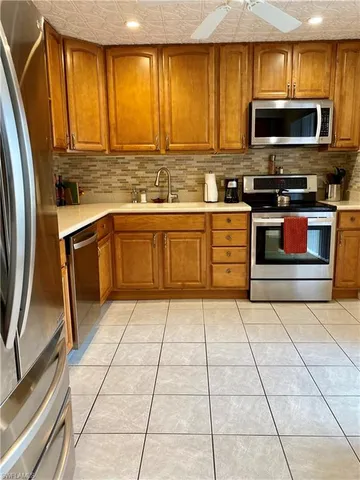 a kitchen with stainless steel appliances a stove a microwave and sink