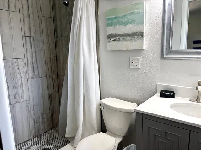 a white toilet sitting next to a bathroom sink