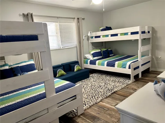 a bedroom with furniture and a baby crib