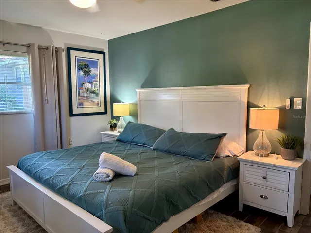 a bedroom with a bed and cabinet