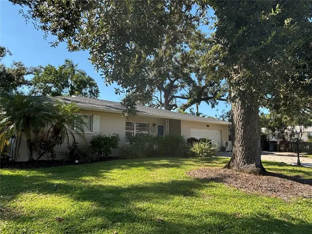 a view of a house with backyard and sitting area